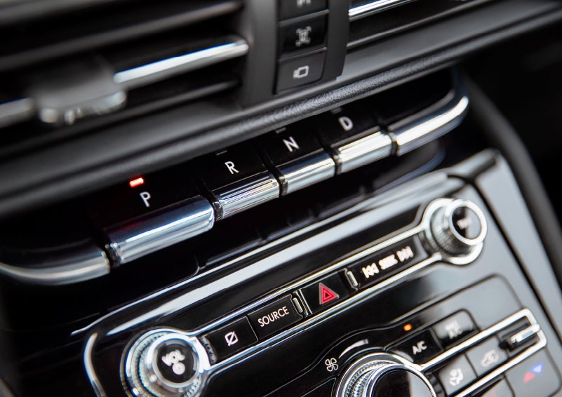 The Park button on the elegant Piano Key Shifter is lit up and engaged as light dances off the chrome accents and horizontal design lines | Bedford Lincoln PA in Bedford PA