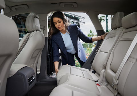 A woman slides the second-row seat forward to create more cargo space | Bedford Lincoln PA in Bedford PA
