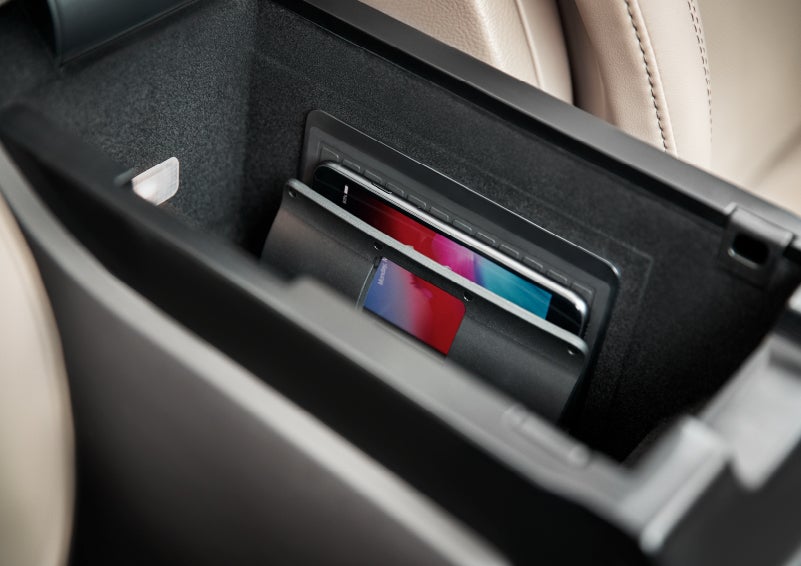 A smartphone device is securely tucked into the available wireless charging pad for an effortless energy boost | Bedford Lincoln PA in Bedford PA