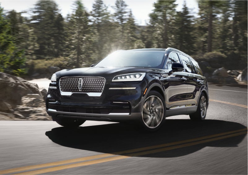 A Lincoln Aviator® SUV is being driven on a winding mountain road | Bedford Lincoln PA in Bedford PA