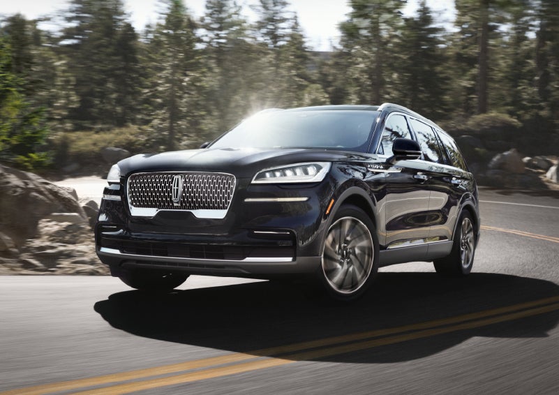 A Lincoln Aviator® SUV is being driven on a winding mountain road | Bedford Lincoln PA in Bedford PA