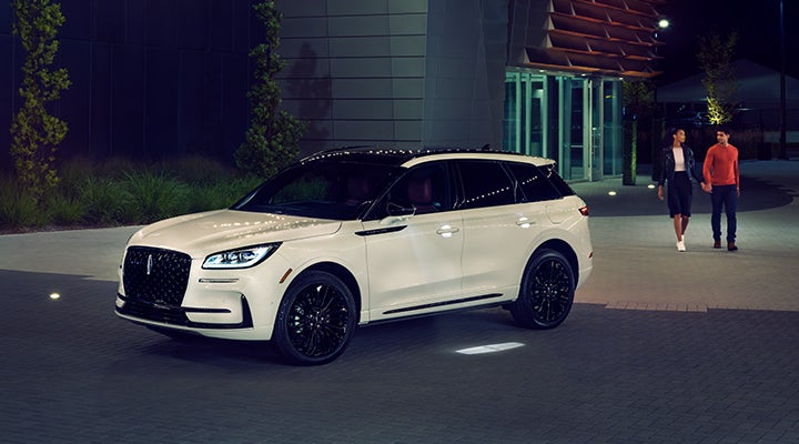 Two people approach a 2024 Lincoln Corsair® SUV featuring the available Jet Appearance Package. | Bedford Lincoln PA in Bedford PA