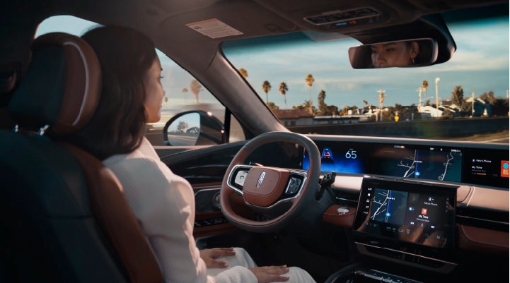 A person is shown driving hands-free on the highway with available Lincoln BlueCruise technology. | Bedford Lincoln PA in Bedford PA
