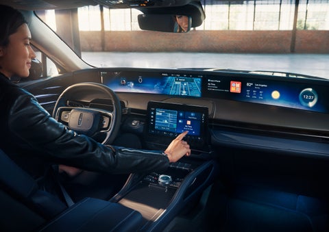 The driver of a 2024 Lincoln Nautilus® SUV interacts with the center touchscreen. | Bedford Lincoln PA in Bedford PA