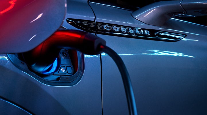 A charger plugged into the charging port of a 2024 Lincoln Corsair® Plug-in Hybrid model. | Bedford Lincoln PA in Bedford PA
