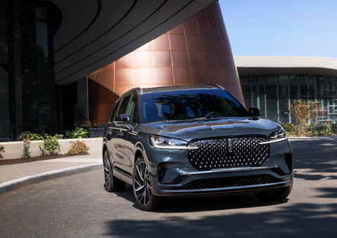 A gray 2025 Lincoln Aviator® SUV is parked outside a modern building with the sun shining. | Bedford Lincoln PA in Bedford PA