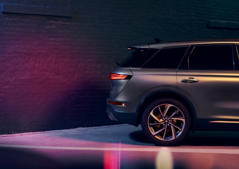 A dramatization of a 2025 Lincoln Corsair® SUV is shown backing up toward a wall. | Bedford Lincoln PA in Bedford PA