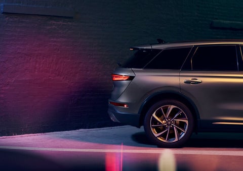 A dramatization of a 2025 Lincoln Corsair® SUV is shown backing up toward a wall. | Bedford Lincoln PA in Bedford PA