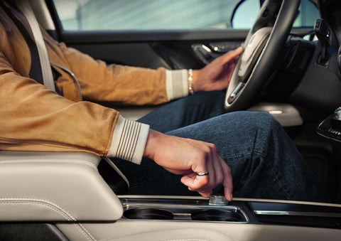 The driver of a 2024 Lincoln Corsair® SUV is shown selecting the drive mode. | Bedford Lincoln PA in Bedford PA