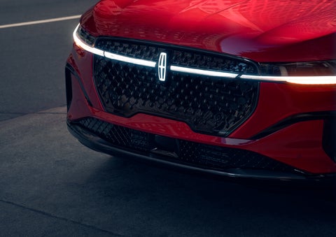 The available front LED light bar and center Lincoln Star logo glow at dusk. | Bedford Lincoln PA in Bedford PA