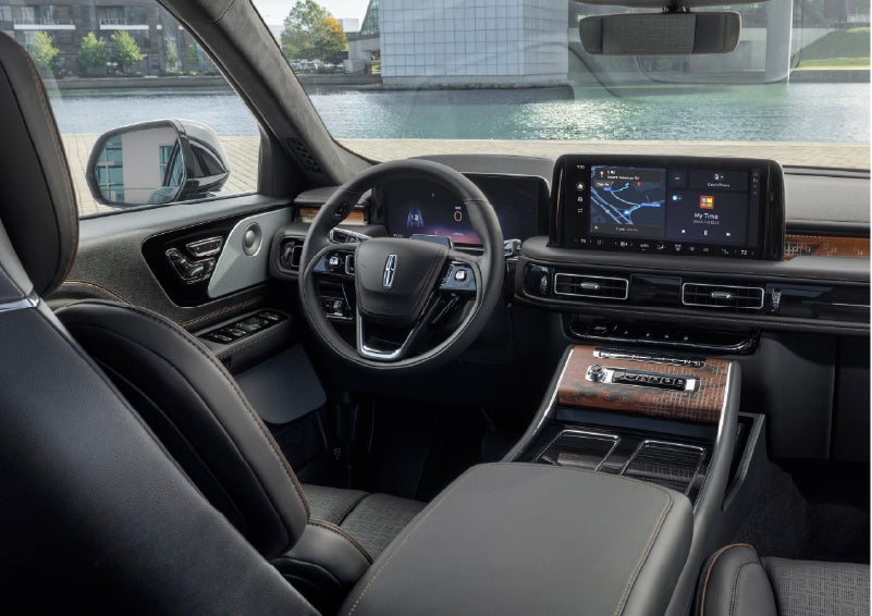 The interior of the 2026 Lincoln Aviator® SUV is shown parked with a view of a harbor through the windshield. | Bedford Lincoln PA in Bedford PA