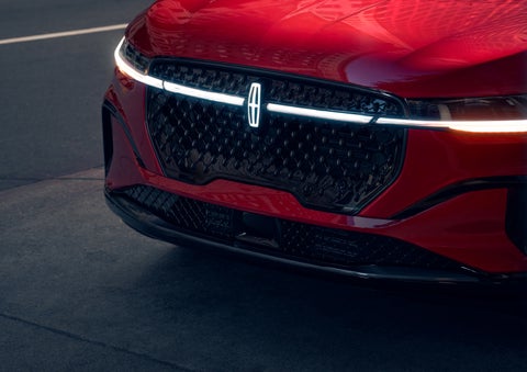 The available front LED light bar and center Lincoln Star logo glow at dusk. | Bedford Lincoln PA in Bedford PA