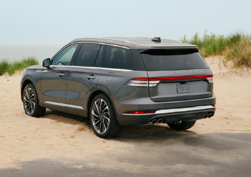A 2027 Lincoln Aviator® SUV is parked next to sand dunes. | Bedford Lincoln PA in Bedford PA