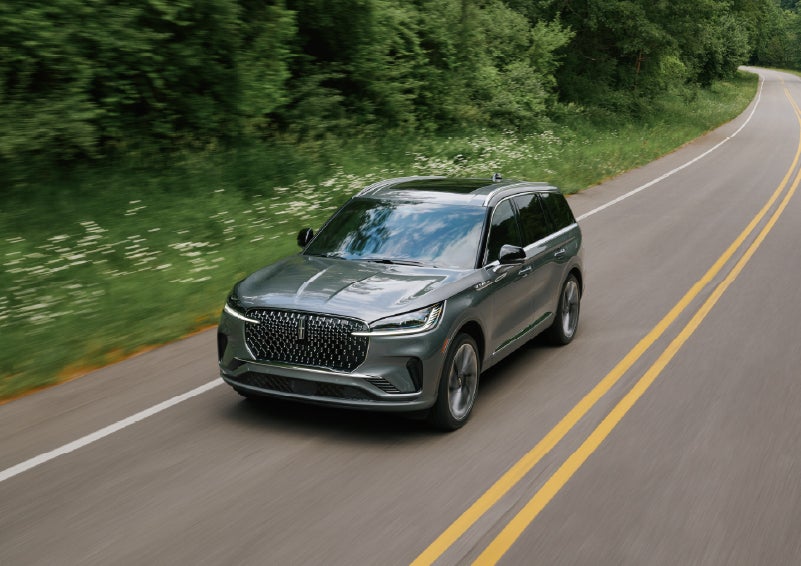 A 2027 Lincoln Aviator® SUV is being driven down a road. | Bedford Lincoln PA in Bedford PA