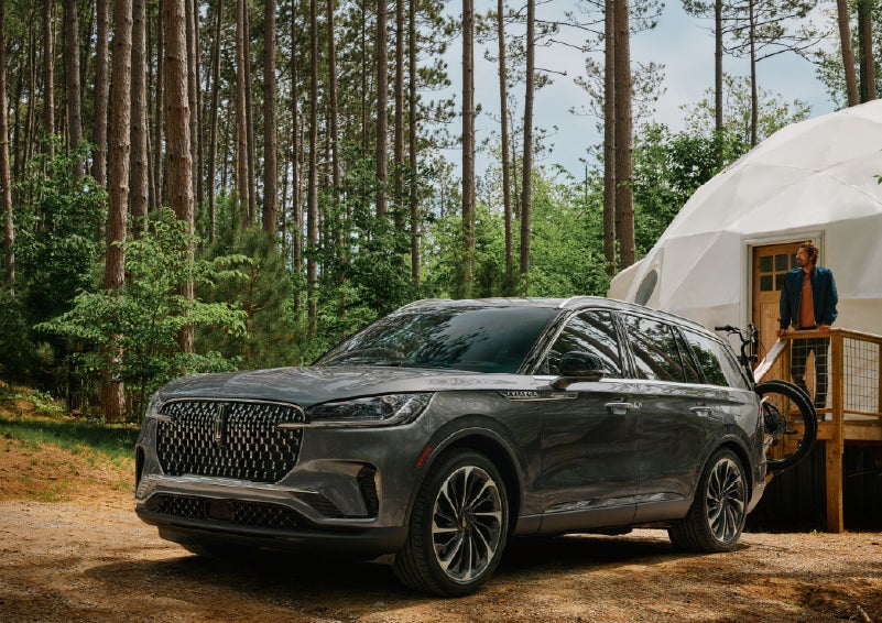 A 2027 Lincoln Aviator® is parked next to a high end glamping site. | Bedford Lincoln PA in Bedford PA