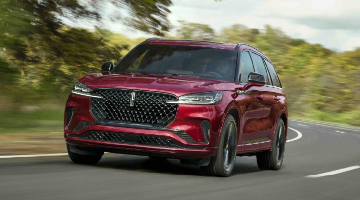 A 2027 Lincoln Aviator® SUV is being driven on a country road | Bedford Lincoln PA in Bedford PA