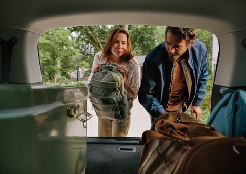 A couple loads luggage into the rear of a 2027 Lincoln Aviator® Black Label™ SUV..e 202 | Bedford Lincoln PA in Bedford PA